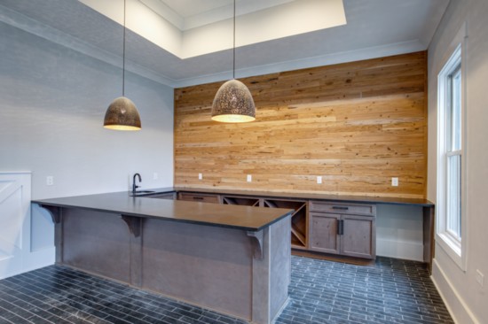 Basement wet bar with natural wood ceiling