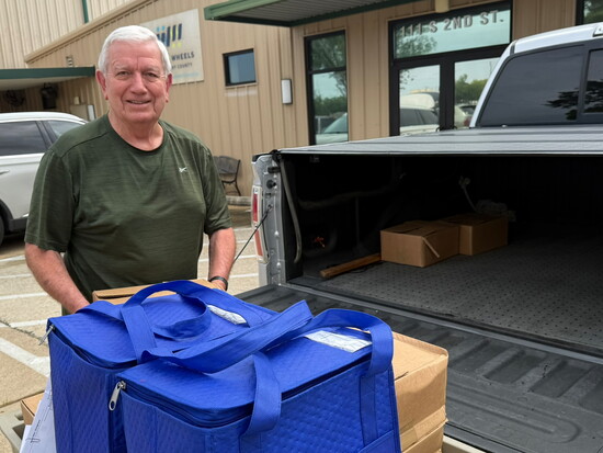 Volunteer of 27 years loading up meals for delivery