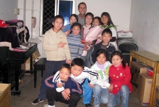 Derek with fellow orphans in China