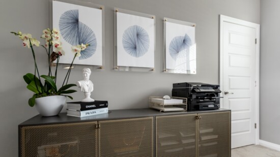 To solve a storage problem in this office, a stylish storage credenza was added as well as new functional accessories. Some of the client’s artwork was also 
