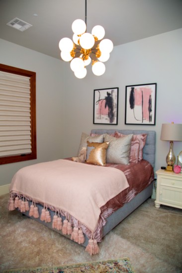 Blakely's bedroom features Nuvo artwork in blush and grays.