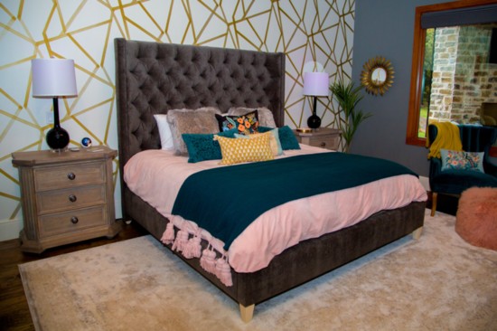 Julie's master bedroom tied in blush and teal to compliment the gray headboard. The walls featured a geometric pattern that adds contour.