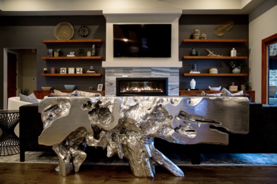 A cast metal sculpture of a tree root makes for a breathtaking console in the living area of the Smith home.