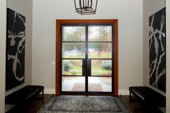 An already impressive entryway is made even more dramatic with artwork from Nuvo Home.