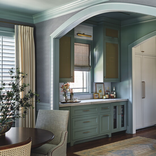 The scullery has a beverage fridge for grab-and-go wine, storage for glassware and counter space to prepare and serve drinks