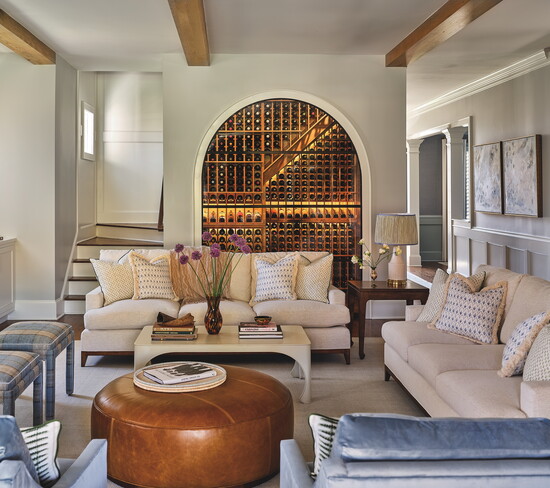 Architect Karen Barton converted the utility closet and buffet under the living room stairs into a show-stopping wine room. It is temperature-controlled with 