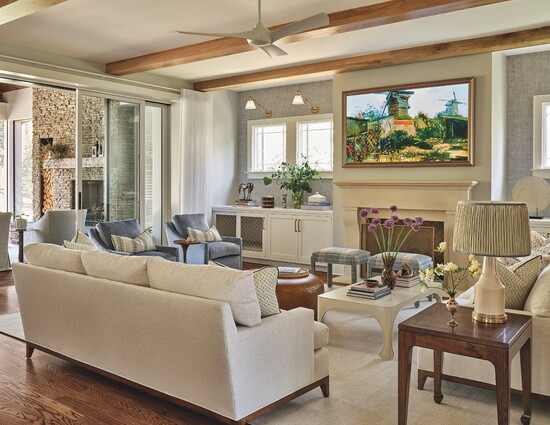 To help create flow from the living room to the covered porch, architect Karen Barton incorporated ceiling beams as well as sliding doors that recess into the