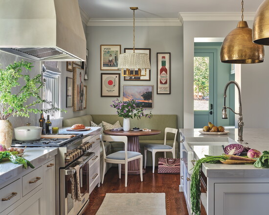 Highland House table is paired with Redford House chairs and a custom corner bench. The gallery wall, with artwork framed by Campania Fine Molding, combines 