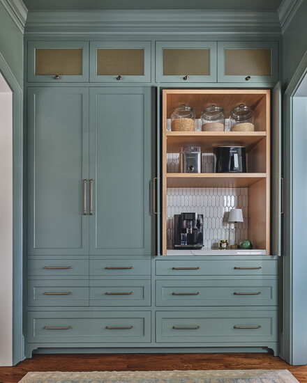 Extended pantry space allows storage and functionality. The drawer under the coffee station contains mugs and condiments. The geometric vertical tile backsplash