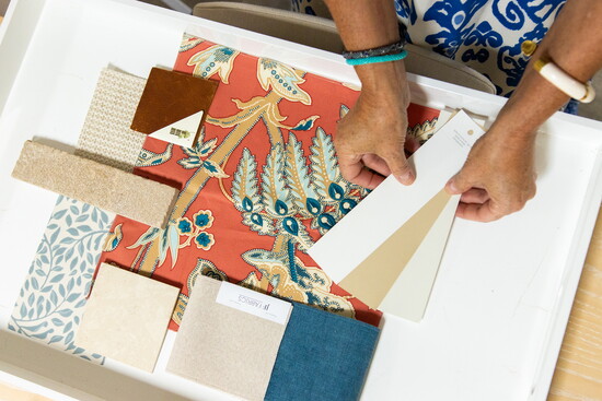 Designers review color and fabric samples, refining the palette that brings the space together.