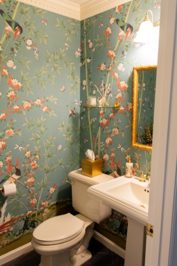 The powder room’s wallpaper is by Schumacher.  