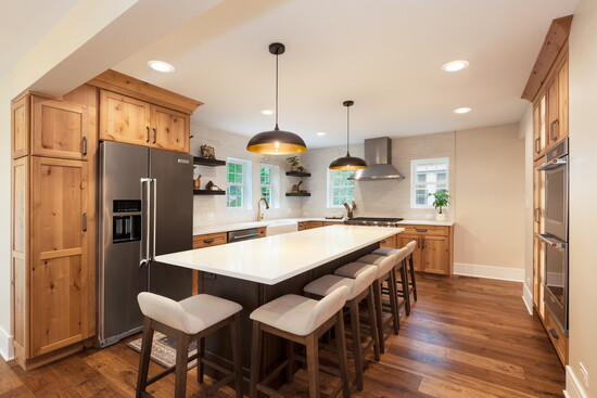 Natural wood tones and shaker-style cabinets are trending today (credit: DDK Kitchen Design Group). 