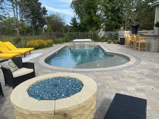 Keyhole Shaped Brookfield Poolscape: The redesigned backyard now includes a pool, hot tub, fire pit, outdoor kitchen, and planter boxes.