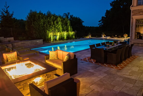 Pewaukee Paradise: The backyard was completely transformed with a custom steel wall vinyl liner pool, rebuilt retaining wall, and new paver deck.