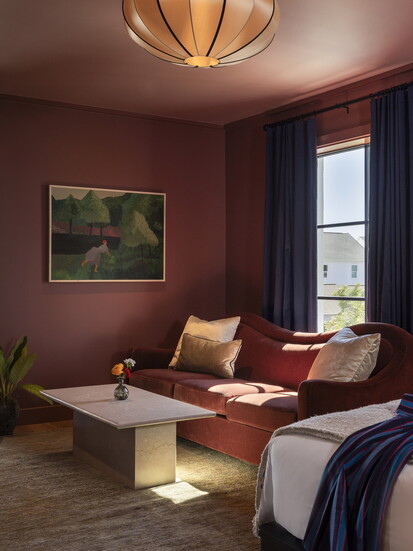 The boutique hotel blends Heights history with modern design across rooms, courtyards, and shared spaces.