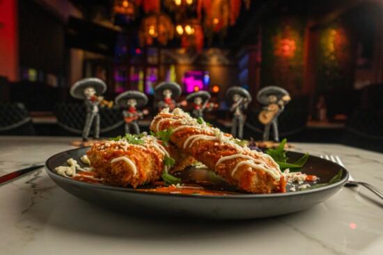 Tamales Empanizados is a popular main entree of two deep-fried corn tamales filled with marinated pork + rajas con queso
