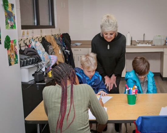 Sandy Buhler, board member of The Cottage School with students 