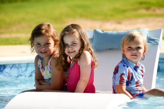 Paisley, Andi and Jordan enjoy pool loungers.