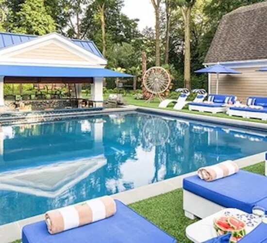 A pool with a colorful pergola from B&B Pool & Spa Center