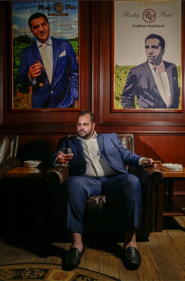 Realtor Jason Dabish poses at Churchill's Bistro & Cigar Bar in West Bloomfield, one of his favorite community respites. Wardrobe by Albaron Tailoring & Clothin