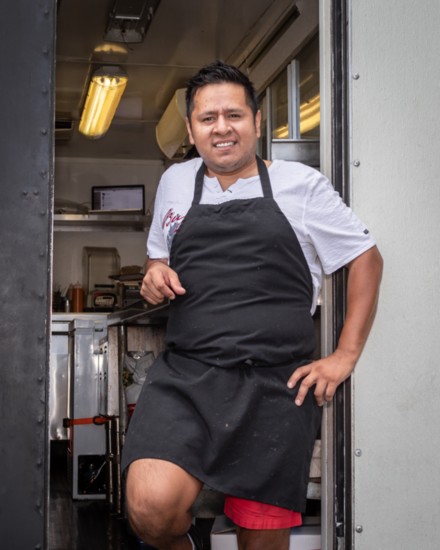 Owner Miguel Martinez poses by the entrance to his food truck.