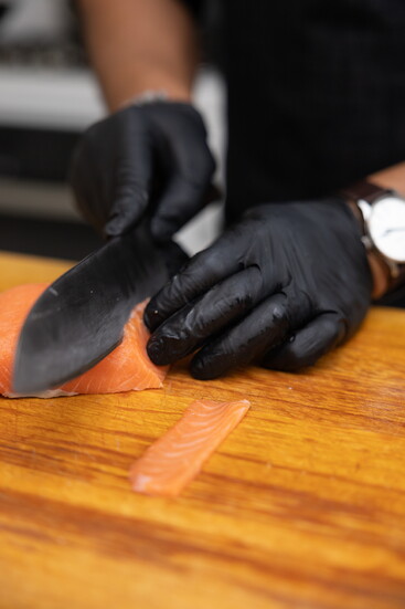 Don crafts sushi with precision, aiming to delight both the eyes and palate.