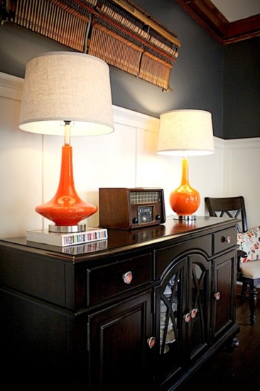 These vintage-inspired orange lamps were just what this space needed. The large artwork is actually the keys from a piano.