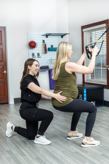 Natalie Crocilla, physical therapist assistant (left), works with a patient.