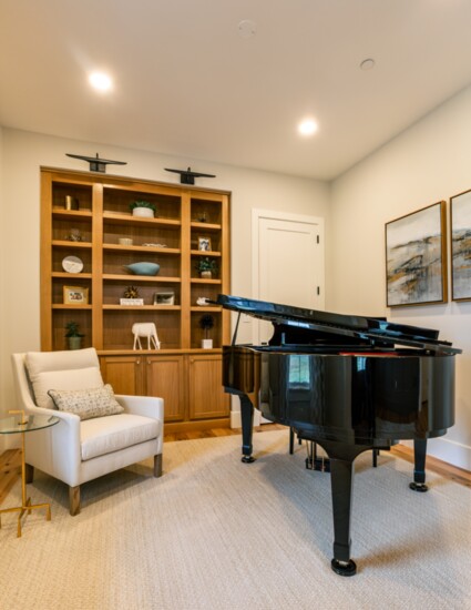 We brought the wood detail from the family room (beams) into the piano room with the wood built-ins. 