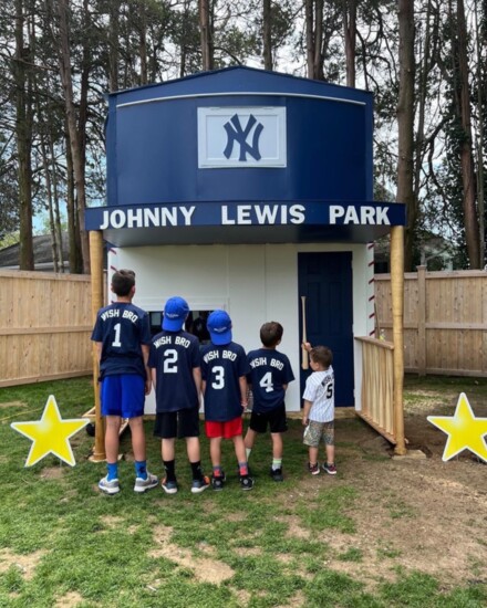 A Make-A-Wish family with their custom Westport Woodworks creation.