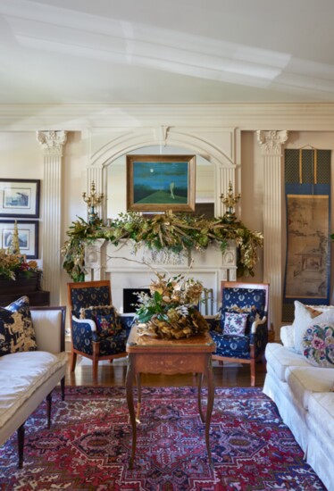 This mantle décor combines store bought fern garland, magnolia leaves, limelight hydrangeas, gold spray painted pine cones and nandina cuttings.