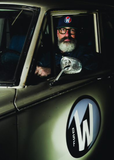 Joel Lueb at the wheel of a classic car emblazoned with the DSF Werks logo.
