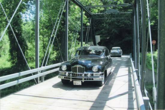 A pair of Packards crosses a vintage bridge near Jarrettsville, Maryland during the 2014 Orphan Car tour. Photo by Ross Miller. 