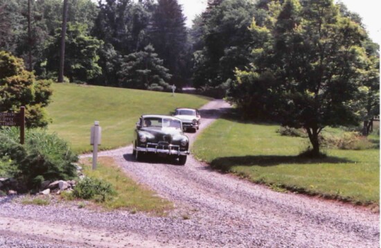A Kaiser and a Packard drive through the State Arboretum of Virginia near Boyce, Virginia on the 2005 Orphan Car Tour. 