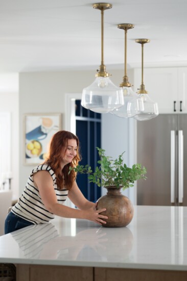 Jessica places a centerpiece on the kitchen island