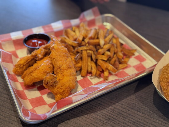 Ms. Lei Lei's buttermilk brined + hand-battered chicken tenders with fresh-cut fries. Don't miss their giant onion rings!