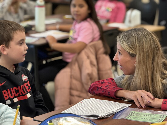 Superintendent Dr. Ashley Whitely engages with a student on their level.