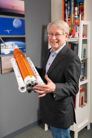 John holds an Estes model of NASA's Artemis Rocket, Destined for the Moon