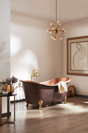 The Cupatitzio Tub, from Thomspon Traders, has a handcrafted antique exterior and solid brass feet. It is finished in hammered antique copper with a hammered ro