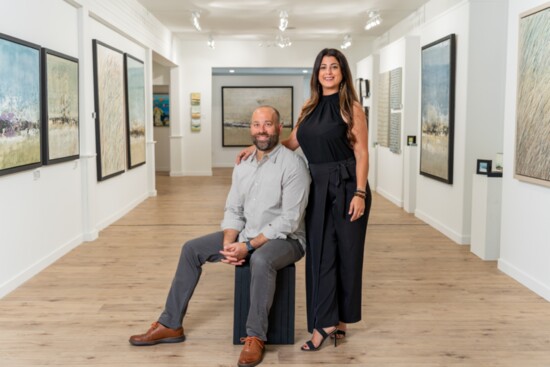 Brad Robertson and Natassa Kouromichelakis, partners at Robertson Gallery, with custom art painted by Brad.