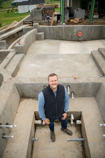 Decker poses in a pool during the construction phase.