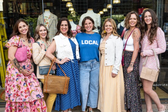 Eccentricity owner Morgan Mattison (center in blue Local t-shirt) is surrounded by models showing off the latest fashions for the season.