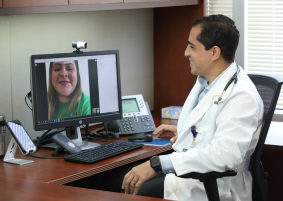 Internist Erik Rivera, MD, conducts a video visit with a patient