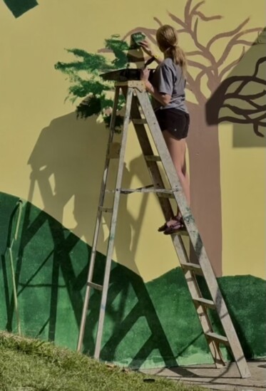 Quincey painting on her mission trip to Jamaica