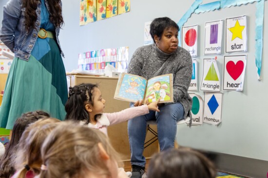 Ms. Tina reads with the Giraffe class.