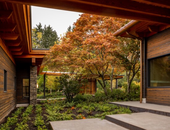 Mature trees and thoughtful landscaping complement the exterior of the home