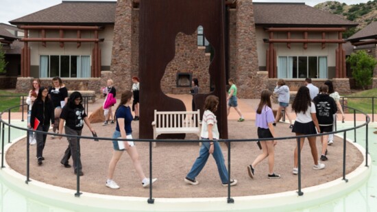 OSAI students encircle a sculpture for a photo opp. (Photo by Evan Beasley)