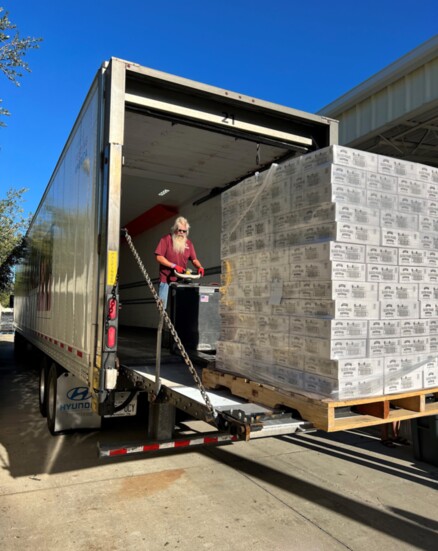 An All Faiths Food Bank worker loads a truck bound for Venice High School.