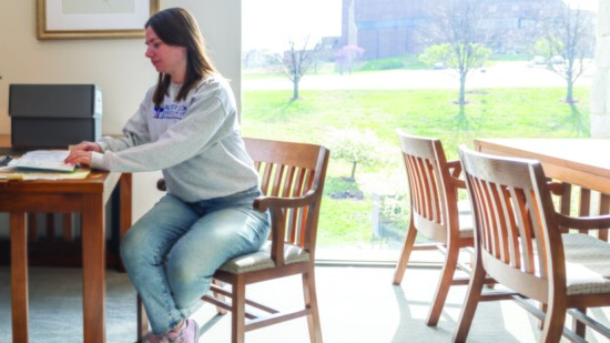 University of Kansas History and Journalism student Alexandra Haggar work on the exhibit.