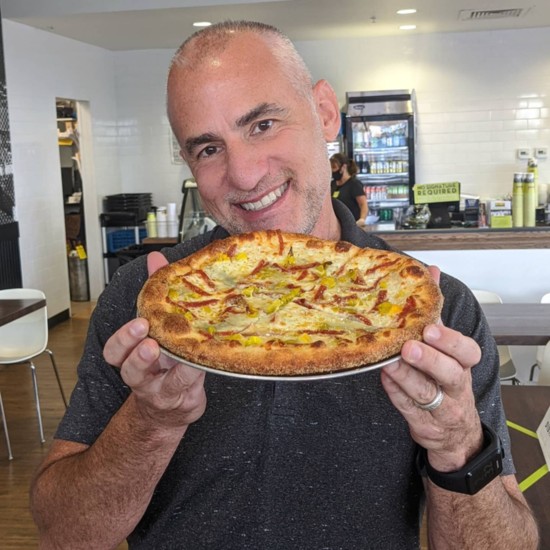 Larry prizes a personal pizza at Mici Italian in Parker